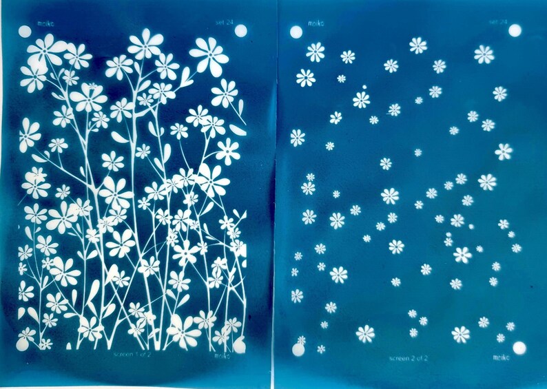 May include: Two cyan blue screens with white floral designs. The left screen has a larger floral design with stems and leaves. The right screen has a smaller, more scattered floral design. The text "screen 1 of 2" is at the bottom of the left screen and "screen 2 of 2" is at the bottom of the right screen.