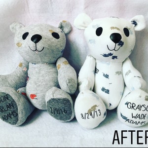 May include: Two stuffed bears made from fabric. The left bear is grey with baseball patterns and has the text EASTON HARLAN ADAMS and 2/9/16 on its feet. The right bear is white with elephant patterns and has 8/24/13 and GRAYSON WADE ADAMS on its feet.