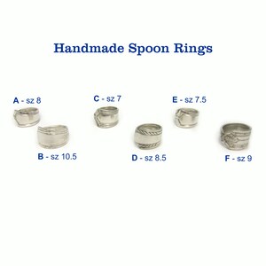 May include: Six silver spoon rings, each with a different size, labelled with letters A through F and their corresponding size in inches. The rings are arranged in two rows of three.