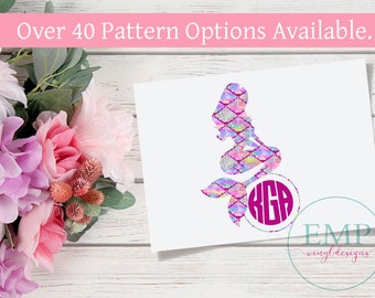 May include: A mermaid silhouette with a colorful scale pattern and a circular monogram. The mermaid is in shades of pink, purple, and silver. The text "Over 40 Pattern Options Available" is above the mermaid. The logo "EMP vinyl designs" is in the bottom right.
