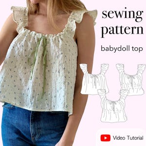 May include: A cream-colored babydoll top with a small blue floral print, ruffled shoulder straps, and a green ribbon tie at the neckline. The image includes the text sewing pattern babydoll top and Video Tutorial, along with three black and white line drawings of the top.
