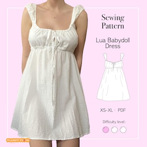May include: White babydoll dress with a textured fabric, square neckline, and tie detail. The dress has puffy straps and a flared skirt. The image includes text that says "Sewing Pattern Lua Babydoll Dress" and "XS-XL PDF".