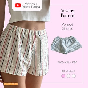 May include: Cream-colored shorts with vertical stripes in red, gray, and blue. The image also shows a smaller pair of blue and white striped shorts. Text on the image reads "Sewing Pattern Scandi Shorts" and "Written + Video Tutorial".