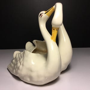 May include: A set of three ceramic mugs with a speckled, matte finish. The mugs are in shades of cream, light gray, and dark gray. Each mug has a simple, minimalist design, perfect for coffee or tea.