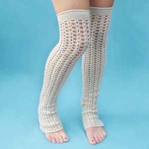 May include: A pair of white crocheted leg warmers with a delicate openwork pattern.