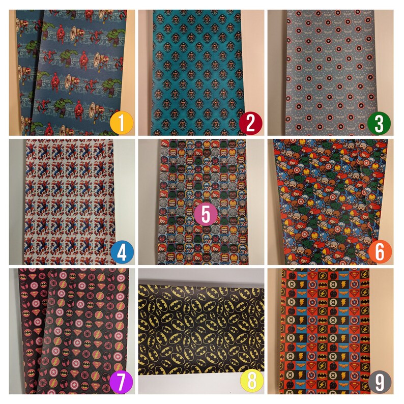 May include: Nine different patterned sheets of wrapping paper featuring various superhero characters, including Spider-Man, Batman, Superman, and the Avengers. The patterns are colorful and vibrant, with a variety of colors and designs.