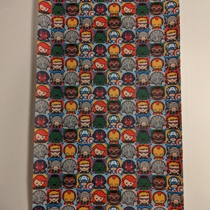 May include: A blue and white wrapping paper with a repeating pattern of small cartoon images of Marvel superheroes, including Iron Man, Captain America, Thor, Hulk, Black Widow, and Hawkeye.