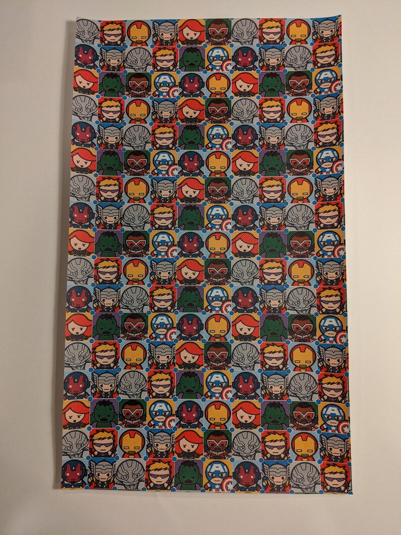 May include: A blue and white wrapping paper with a repeating pattern of small cartoon images of Marvel superheroes, including Iron Man, Captain America, Thor, Hulk, Black Widow, and Hawkeye.