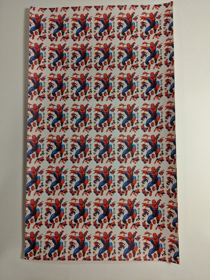 May include: White fabric with a repeating pattern of a red and blue Spiderman character.