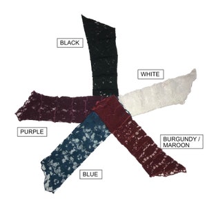 May include: Five fabric swatches in different colours, arranged in a star shape. The colours are black, white, purple, blue, and burgundy/maroon.