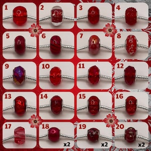 May include: Twenty red glass beads with various designs and textures, including clear, speckled, and striped patterns. The beads are arranged in a grid on a white background.