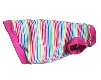 May include: A rainbow striped dog shirt with pink trim. The shirt is made of a soft, comfortable fabric and has a relaxed fit.