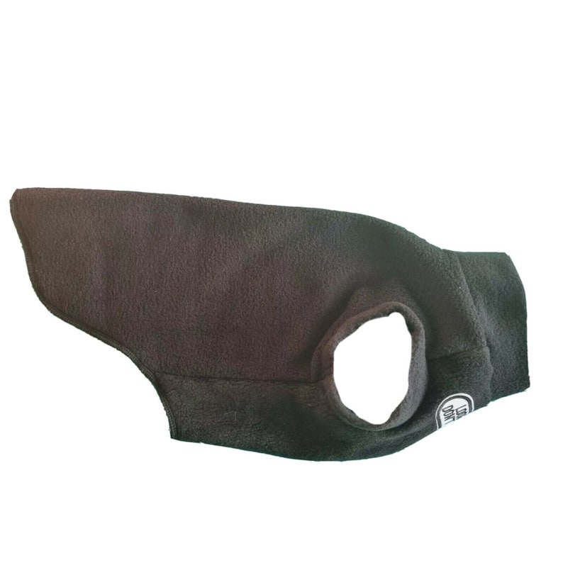 May include: A black dog coat made of fleece material. The coat has a circular opening for the neck and a small tag with text. The coat is designed to provide warmth and comfort for dogs.