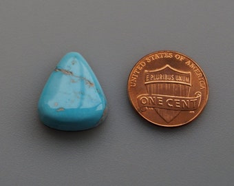 May include: A turquoise cabochon gemstone in a teardrop shape, measuring approximately the size of a US penny.