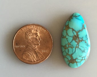 May include: A turquoise cabochon gemstone with a brown matrix. The stone is teardrop shaped and measures approximately the size of a US penny.