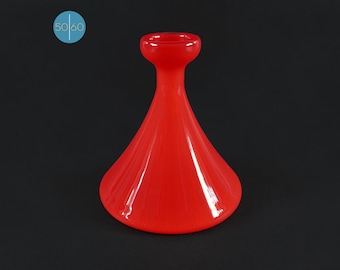 May include: A bright red glass vase with a flared base and a narrow neck. The vase has a smooth, glossy finish.