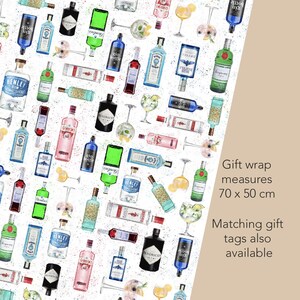 May include: Gift wrap with a pattern of gin bottles, cocktail glasses, and floral accents on a white background. The gift wrap measures 70 x 50 cm. Matching gift tags are also available.