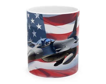 May include: White ceramic mug featuring a gray fighter jet soaring against a backdrop of the American flag. The design includes the red and white stripes and blue field with white stars. A patriotic themed mug.