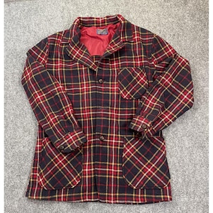 May include: A vintage plaid jacket in a classic pattern of red, black, and yellow. The jacket features a collared neckline, two front pockets, and button closures. The interior lining is red.