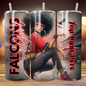 May include: A stainless steel tumbler with a black and red design. The tumbler features a woman wearing a red jersey with the word "FALCONS" in large red letters. The tumbler also has the text "Your Name Here" on the side.