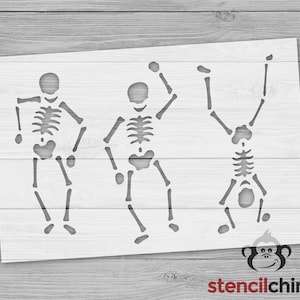 May include: Stencil design featuring three skeletons dancing. The skeletons are outlined in black and are in a simple, cartoon style.