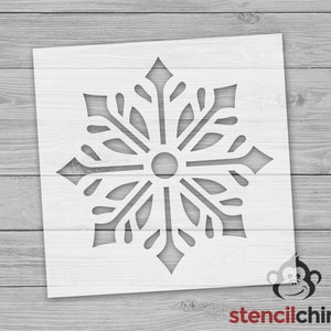 May include: White snowflake stencil with a detailed design. The stencil is made of a durable material and is perfect for creating beautiful snowflake designs on walls, furniture, and other surfaces.