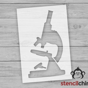 May include: A white stencil of a microscope, a scientific tool used for viewing small objects. The stencil is on a wood background.