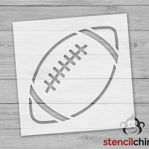 May include: A white stencil of an American football. The stencil is designed for use with paint or other mediums to create a football design.