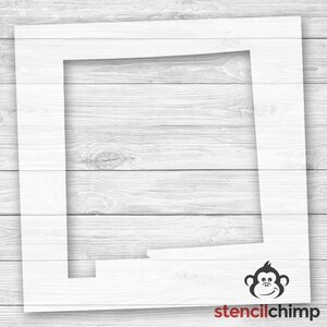 May include: A white stencil of the state of New Mexico. The stencil is on a white wood background. The stencil is for use with a craft project.