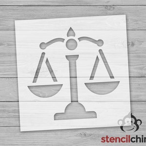 May include: A white stencil of a scale with two pans, a central pillar, and a decorative top. The stencil is designed for crafting and decorating projects.