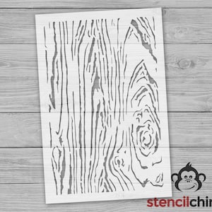 May include: A stencil featuring a wood grain pattern. The stencil is white and has a detailed design of wood grain.