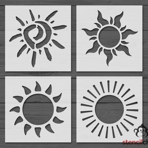 May include: Four different sun stencil designs. The stencils are white and are on a gray wood background. The sun designs are simple and modern.
