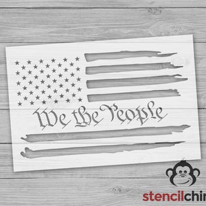May include: A stencil of a distressed American flag with the words "We the People" in a script font.