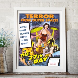 May include: A vintage movie poster for the film "The 27th Day" featuring a woman in a red dress and a flying saucer. The poster text reads "Terror from Outer Space!" and "Mightiest Shocker The Screen Ever Had The Guts To Make!"