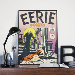 May include: Framed vintage "Eerie Comics" comic book cover art. The artwork features a dramatic scene with a robed figure, a woman in a red dress, and the text "EERIE COMICS". The comic is an Avon comic and is marked "10&cent;".