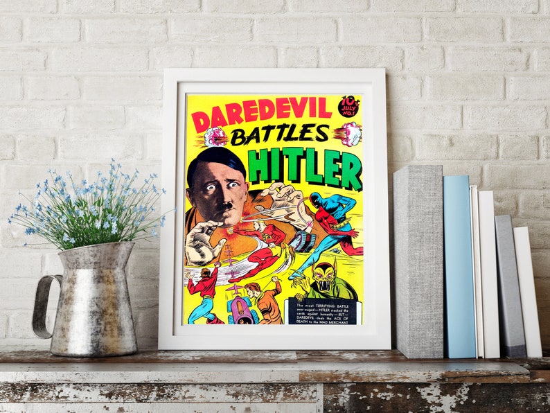 May include: A vintage comic book cover featuring Daredevil battling Hitler. The cover is yellow with red, green, and black text. The image shows Daredevil fighting Hitler and other Nazi soldiers.