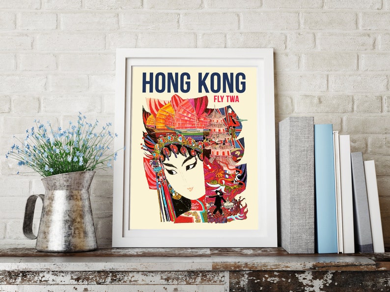 May include: Vintage travel poster advertising a trip to Hong Kong with the text "Hong Kong Fly TWA". The poster features a colorful illustration of a woman in traditional Chinese clothing with a pagoda and other buildings in the background.