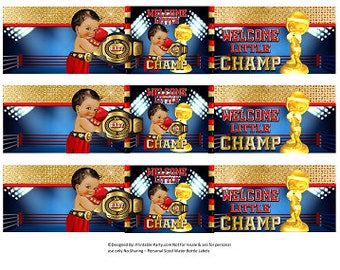 May include: Three printable bottle labels with a blue and red boxing ring background. The labels feature a cartoon illustration of a baby wearing boxing gloves and a gold championship belt. The text on the labels reads "Welcome Little Champ".