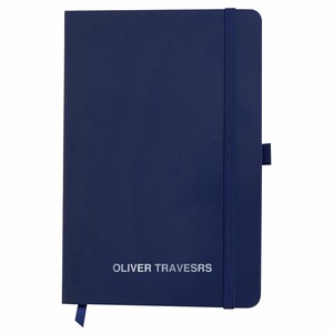May include: A dark blue notebook with a matching elastic closure and the text "OLIVER TRAVERSRS" printed in silver on the front cover.