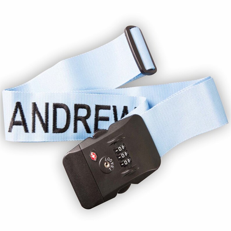 May include: Light blue luggage strap with a black combination lock and the name "ANDREW" embroidered in black.