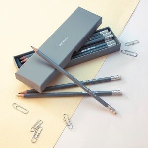 May include: A gray box with a set of gray pencils. The pencils are labeled "Amir Mehta".