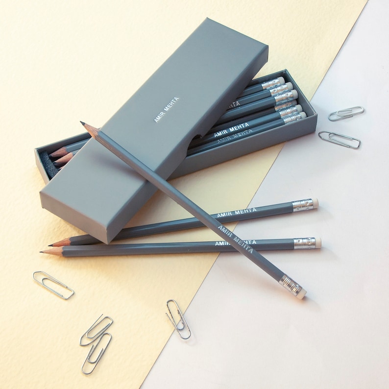 May include: A gray box with a set of gray pencils. The pencils are labeled "Amir Mehta".