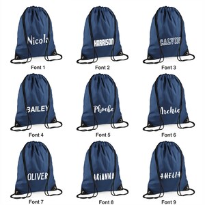 May include: Nine navy blue drawstring bags with white text. Each bag has a different name: Nicola, Harrison, Calvin, Bailey, Phoebe, Archie, Oliver, Arianna, and Amelia. The bags are arranged in three rows of three.
