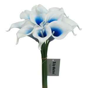 May include: A bouquet of white calla lilies with blue accents. The stems are tied with twine and a tag that reads "Lily Garden".