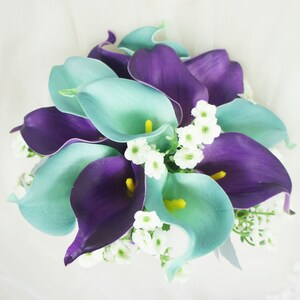 May include: A bouquet of artificial calla lilies in shades of teal and purple, accented with small white flowers.