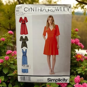 May include: A Cynthia Rowley Simplicity sewing pattern, featuring a red dress design. The pattern includes illustrations of dresses in red, black, and blue. The pattern number is 1801.