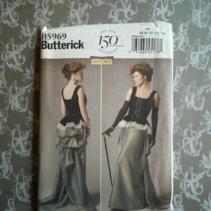 May include: Butterick sewing pattern B5969 for a two-piece ensemble featuring a black corset-style bodice with lace trim and a long, flowing skirt. The package displays the 150th anniversary logo, size range A5 (6-8-10-12-14), and a barcode.