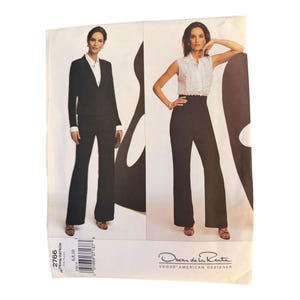 May include: A Vogue American Designer sewing pattern envelope for Oscar de la Renta design 2766, size 6, 8, 10. The front displays two outfits: a black blazer with white shirt and trousers, and a white ruffled sleeveless top with black trousers.