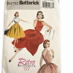 Op de afbeelding: Een Butterick B4792 naaipatroon-envelop met illustraties van drie outfits. De tekst bevat Butterick, Retro Butterick '57 en maat EE (14-16-18-20). De illustraties tonen een gele rok met een wit topje, een rode jurk en een roze jurk.