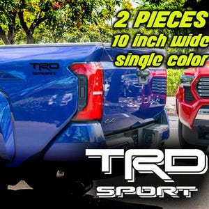 May include: Two black vinyl decals, each 10 inches wide, with the text "TRD SPORT" in white lettering. The decals are shown on the back of a blue pickup truck.